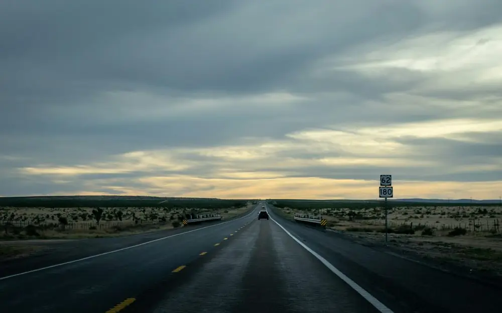 A car on a West Texas highway at dusk